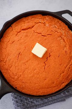 a pan with some food in it and a piece of butter sitting on top of it