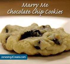 a close up of a cookie on a plate with the words marry me chocolate chip cookies