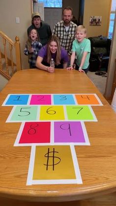 a group of people standing around a table with a board game on top of it