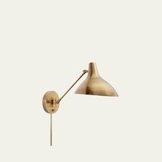 an antique brass wall lamp on a white background, with the light turned off and dimming