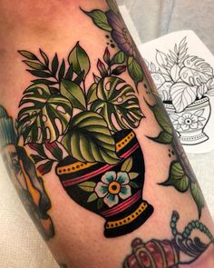 a close up of a person's arm with a potted plant on it