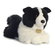 a black and white stuffed dog laying down