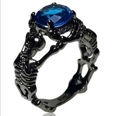 Available Ring Sizes: 6, 8 Material: Crystal And Zinc Bundle And Save. All Jewelry Is Buy One Get One Half Off. Message Me To Create Your Bundle. Shameless Sales Pitch: Do You Like Skeletons? Well He're 2 Black Colored Skeletons Holding Up A Beautiful Blue Gem. What Could Be A More Beautiful Combination. Black And Blue Themed Wedding, Edgy Black Metal Skull Ring, Black Metal Skull Ring As Gift, Black Metal Skull Ring Gift, Black Metal Skull Ring, Black Metal Skull Ring For Gift, Edgy Black Skull Ring For Halloween, Gothic Black Skull Ring For Halloween, Black Skull Jewelry Grunge Style