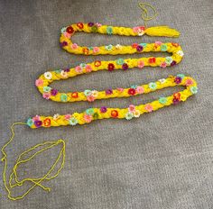 the yellow string has flowers on it