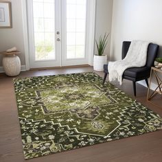 a living room with a green rug and black chair in front of the door that is open