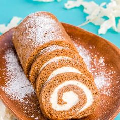 a cinnamon roll on a plate with powdered sugar sprinkles around it