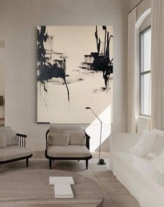 a living room filled with furniture and a painting on the wall