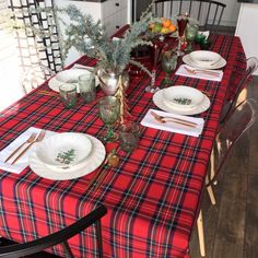 the table is set with dishes and place settings for two people to sit down at