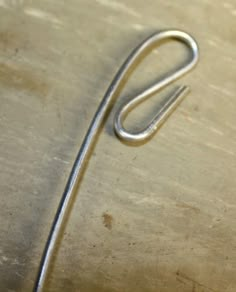 a pair of scissors sitting on top of a piece of metal