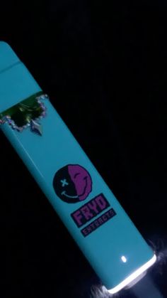 a close up of a blue toothbrush on a black background with the words fyro printed on it