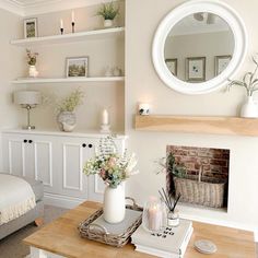 a living room filled with furniture and a fire place next to a fireplace covered in candles