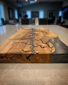 a wooden cutting board sitting on top of a counter