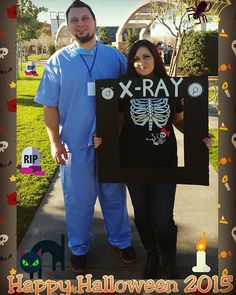 a man and woman standing next to each other in front of a halloween photo frame