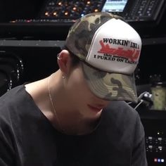 a person wearing a hat with the words workin'in red on it