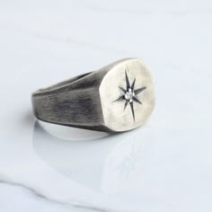 Silver stone compass men ring has been carefully designed and handcrafted for you, inspired by the unique pole star that shines brightly in the darkness of the sky. We presented our ring as white bronze (silver plated) or 925 sterling silver. This ring, which is suitable for daily use and at the same time very stylish, can be an anniversary gift or a memorial gift for your loved ones, and it will come properly packaged as a gift. As NuaSilverRings, we guarantee that we will help you with any pro Rings Signet, Black Closet, Cool Rings For Men, Man Ring, Men Rings, Signet Ring Men, Pole Star, Men's Outfits, Biker Rings