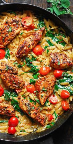 pasta with chicken, tomatoes and spinach in a skillet