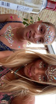 two women with face paint and body art on their faces, one woman has long blonde hair