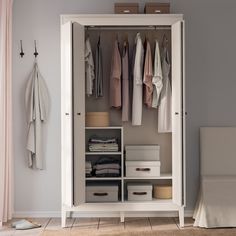 an organized closet with clothes hanging on the wall and a potted plant next to it