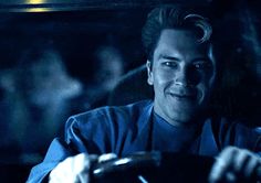 a man driving a car in the dark