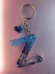 the letter z is made out of glass and has a keychain attached to it