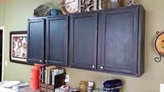 the kitchen cabinets are painted blue and have pictures on them, along with other items