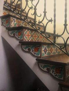 a stair case with decorative tiles on it