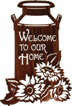 a wooden sign that says welcome to our home with flowers on the front and bottom