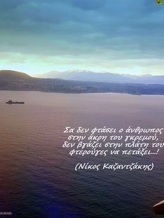 an airplane flying over the ocean with a quote written on it's side and mountains in the background