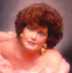 an old photo of a woman with large earrings on her head and hair in curls