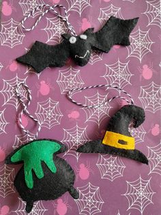 two felt witches hanging on a purple background