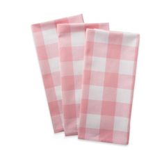 two pink and white checkered napkins sitting on top of each other