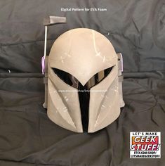 a helmet that is on top of a black sheet with the words let's make geek stuff