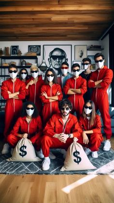 a group of people dressed in red are posing for a photo with money bags on the floor