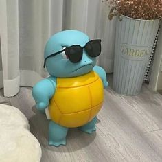 a small toy turtle with sunglasses on it's head