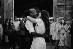 a man and woman dance in front of a group of people