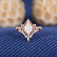 a close up of a diamond ring on a blue cloth