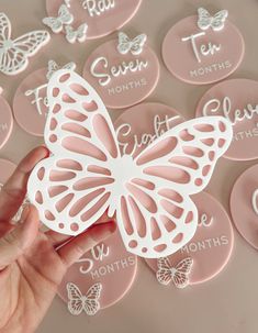 a hand holding a pink and white butterfly with the words, i love you month on it