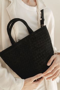 NEW! The Onyx Suede Tote is this season's must-have bag to take you through winter. Crafted from luxurious black suede, the hand woven design exudes sophistication and timeless elegance. The top zip closure and crossbody strap provide convenience and the interior pockets offer extra security and organization. Color: Onyx (Black) Handwoven suede leather Includes crossbody strap. Interior pockets Top zip closure Gold hardware Dimensions Length: 12 in / 30 cm Height with handle: 13 in / 33 cm Heigh Luxury Suede Bag With Zipper Closure, Black Suede Luxury Shoulder Bag, Luxury Black Suede Shoulder Bag, Luxury Black Suede Bags, Chic Suede Bag With Zipper Closure, Black Suede Bag With Detachable Strap, Black Suede Bags For Daily Use, Black Suede Crossbody Bag, Suede Bag