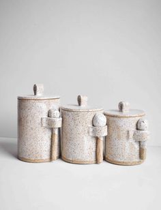 three white canisters sitting next to each other