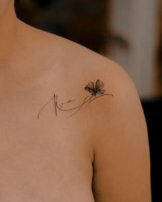 a woman with a flower tattoo on her shoulder