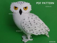 a white owl with yellow eyes on a green background