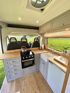 a kitchen area with an oven, sink and dishwasher in a recreational vehicle