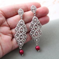 Vintage style  earrings  with pearls Colour: rhodium(silver tone) /clear/dark red/burgundy. Measurements: approx 7.8 cm . Width approx 2 cm. Materials:  rhodium components, clear crystal rhinestones, dark red/burgundy shade faux pearls 6-7 mm. Stud earrings. Great for wedding or other celebration. MORE SAME STYLE: https://www.etsy.com/uk/shop/BridalArtDeco?ref=listing-shop-header-item-count&section_id=23918122 Please note some images have been enlarged to allow for details to be shown. Read the descriptions for details on actual size of each item.In all my shop listing I have made every effort to ensure that the images match the item as closely as possible! However, colours do vary on different monitors.  Thank you for visiting / shopping ! Red Pearl Earrings For Wedding, Red Pearl Drop Earrings For Wedding, Elegant Red Bridal Earrings With Pearl Drop, Statement Pearl Earrings, 1920s Earrings, Bridal Earrings Statement, Crystal Cluster Earrings, Pearl Statement Earrings, Art Deco Hair