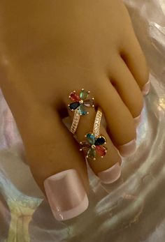 This gold retro flower power toe ring features two  vibrant multicolored flowers with crystal acccents  that flow below each flower. This toe ring is size adjustable and one size fits most. Comfortable and versatile, it will lend itself to casual or formal events. All items are made in a smoke free environment. *If there is any issue with your toe ring, please let me know so that I can correct it. Thanks for visiting my shop!👣 Adjustable Multicolor Flower Ring, Adjustable Multicolor Toe Rings, Multicolor Adjustable Flower Ring, Joan Severance, Jennifer O'neill, Shannon Tweed, Exercise Sandals, Multicolored Flowers, Teri Hatcher