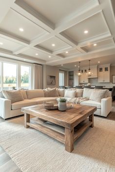 a living room filled with furniture and a wooden table in front of a large window