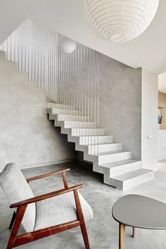 a room with stairs and a chair in it