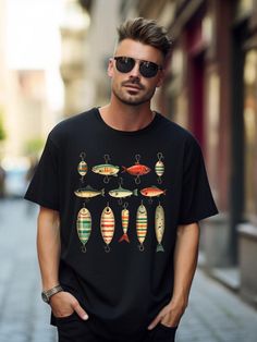 a man standing in front of a building wearing a black shirt with fish on it