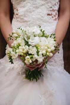 a bridal holding a bouquet of white flowers