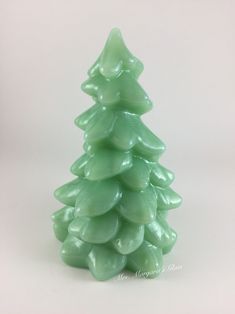 a green glass christmas tree on a white background