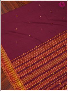 This Bhujodi/Kala cotton handloom saree is perfect for the summer season. The rich maroon hue creates an elegant backdrop for the traditional design. The pallu with simple geometric patterns are the highlights of Bhujodi Sarees. The wrap fringe of handmade tassels at the edge complements the weave. This saree comes with a fine red cotton blouse fabric with border. Fall and Pico - Done. Blouse - Unstitched. Please note: Color may vary slightly from the picture. Thread knots, Thread pulls and mino Thread Knots, Elegant Backdrop, Simple Geometric Pattern, Cotton Blouse, Handloom Saree, Blouse Fabric, Cotton Blouses, Geometric Patterns, Summer Season